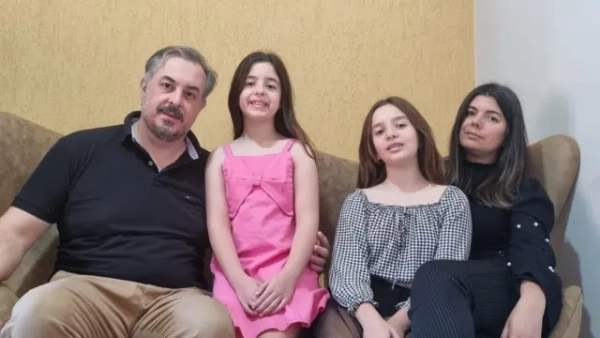 Родина Бернарді сидить разом на дивані й усміхається в камеру. Зліва направо: батько Бруно Бернарді, Беатріс Бернарді (8 років), Лара Бернарді (10 років) і мати Лея Бернарді.